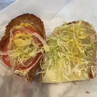 a sandwich with lettuce and tomato