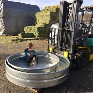 Our son Jaxon enjoying the ride while his uncle Phil organizes the yard.