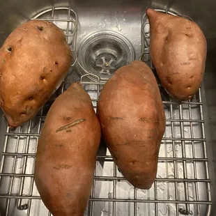 three sweet potatoes in a sink