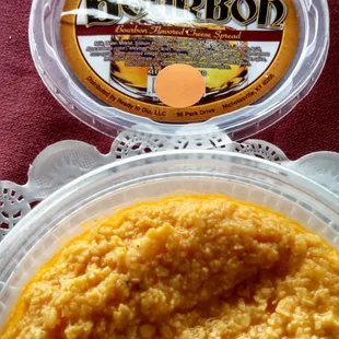 a bowl of dip and a container of dip