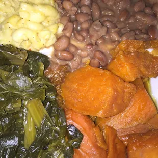 Vegetarian delight: delicious Mac n cheese, flavorful collard greens, sweet yams, and seasoned pinto beans.