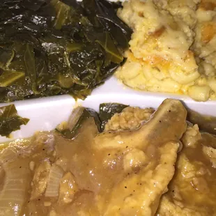 Smothered southern pork chops, Mac n cheese, and collard greens. All that's missing is the rice to catch the gravy!
