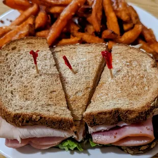 a cut in half sandwich and fries