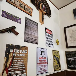 a wall of guns and posters