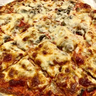 a pizza with cheese and olives