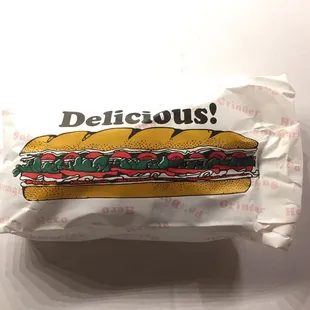 a sandwich wrapped in paper