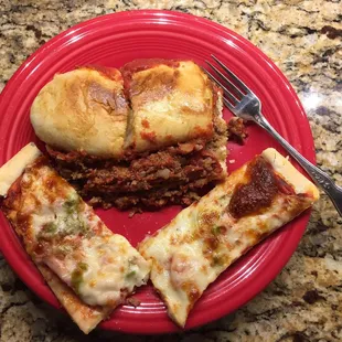 a slice of pizza on a red plate