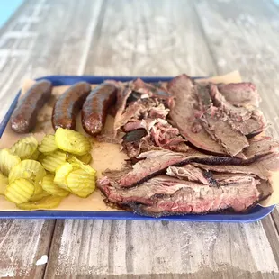 a plate of meat and pickles