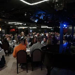 a crowd of people sitting at tables