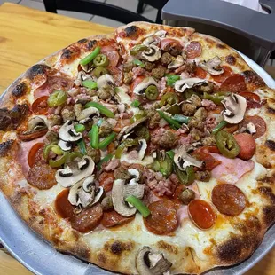 All meat medium pizza with mushrooms, onion and jalapeños added. Half white sauce half tomato sauce.