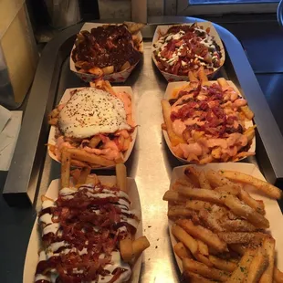 Variety of specialty fries: grub fries, chili fries, glen fries (egg), stewart fries, BBQ bacon ranch, and garlic Parmesan fries. Yum!