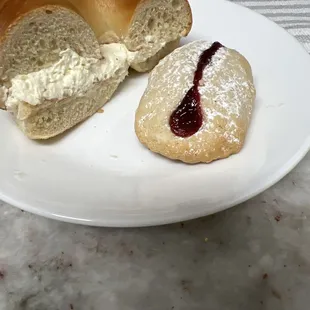 Plain Bagel with Plain Cream Cheese And a baked good with jam.