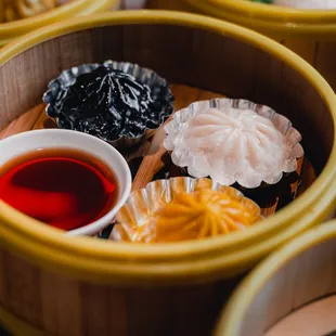 Squid ink black truffle xlb, regular xlb, and crab roe turmeric xlb