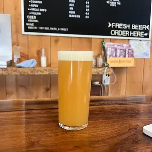 a glass of beer on a bar
