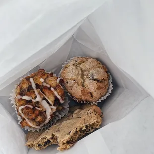 Bread pudding, banana muffin and partially eaten chocolate chip cookie