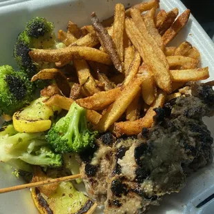 Steak skewers, seasoned fries, and vegetables