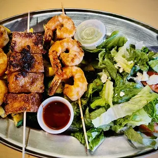 Shrimp and tofu with salad and mixed vegetables.