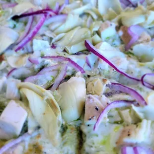 a pizza with artichokes and chicken