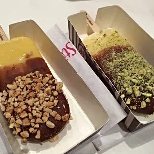 Left: banana half dipped with peanuts; Right: vanilla half dipped with pistachios