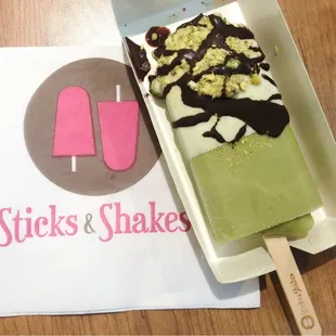 Green Tea Stick, Half-dipped in White Chocolate, Sprinkled with Pistachios and Milk Chocolate!