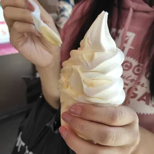 a woman holding a cup of ice cream