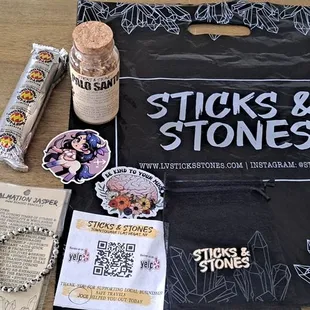 Charcoal discs, palo santo chips in a bottle, stickers and a super cute small bracelet.