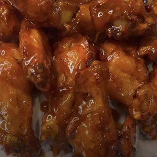 a plate of chicken wings covered in sauce