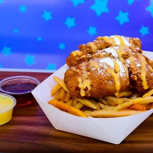 a basket of french fries with sauce