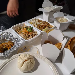 Bbq steam bun, thai sausage, lemon grass chicken, fuck pad thai, pang curry hiding, 2 appetizer containers. Sticky rice and regular rice.