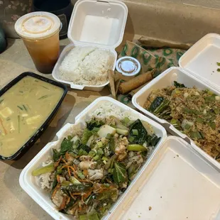 From left to right: yellow curry, Thai iced tea, garlic chicken stir fry, egg rolls with sweet &amp; sour sauce, drunken fried rice