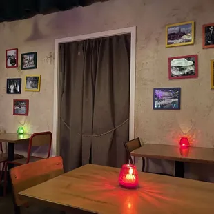 a dining area with a table, chairs, and pictures on the wall