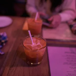 two glasses of juice on a table