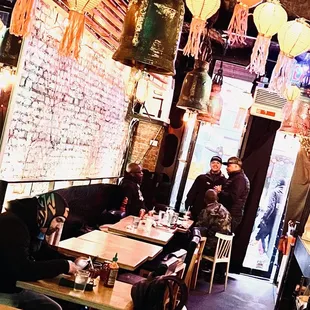 people sitting at tables in a restaurant