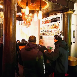 a group of people sitting at a bar