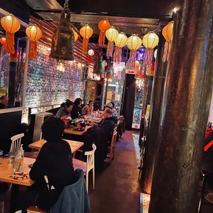 people sitting at tables in a restaurant