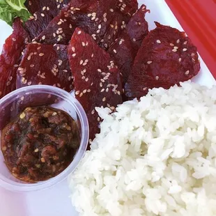 The number 3 beef jerky/heavenly beef. The jerky itself isn't spicy. The spice comes from the chili chutney that comes ON THE SIDE