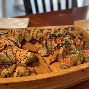 a wooden boat filled with sushi