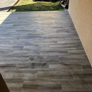 a patio with a wooden floor