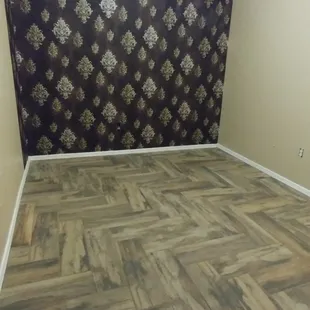 an empty room with wood floors