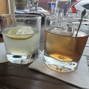 a glass of whiskey and a glass of lemonade