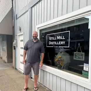a man standing in front of a store