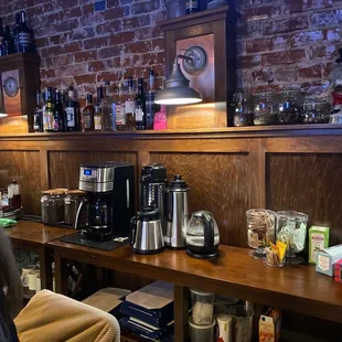 a coffee bar with a brick wall