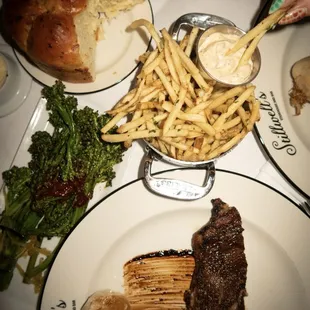 steak, fries, broccolini, house bread