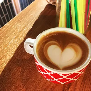 a cup of coffee with a heart in the foam