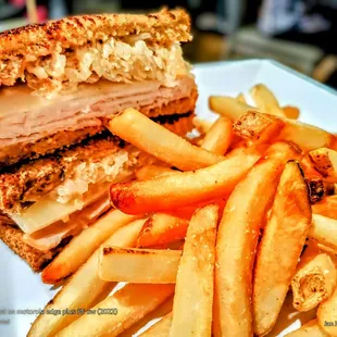 "Classic Turkey Reuben". Grilled Turkey, Melted Swiss, Toasted Rye, Kraut + Russian Dressing w/ French Fries.