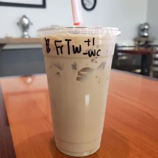 a cup of iced coffee with a straw