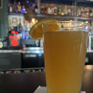 a glass of orange juice on a napkin