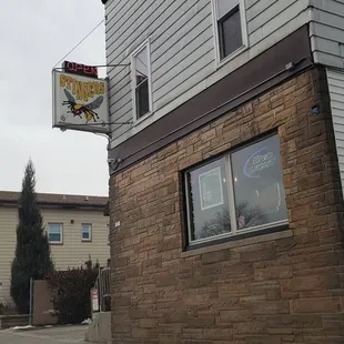 a view of a street corner with a building and a truck parked in front of it
