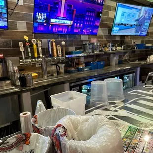 a restaurant counter with bags of food