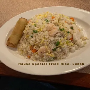 a plate of rice with shrimp and vegetables